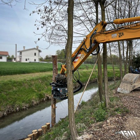 Enfonce-pieux hydraulique en installation près d'une berge.